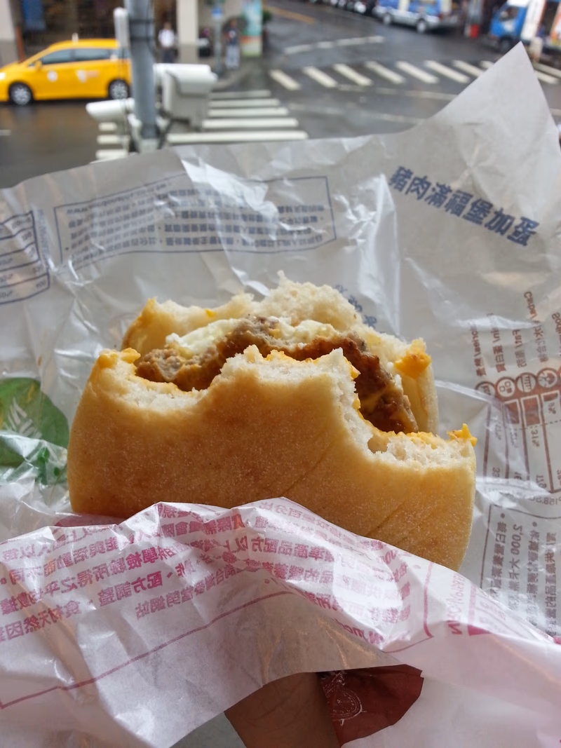 A close-up of a partially eaten food item wrapped in paper.